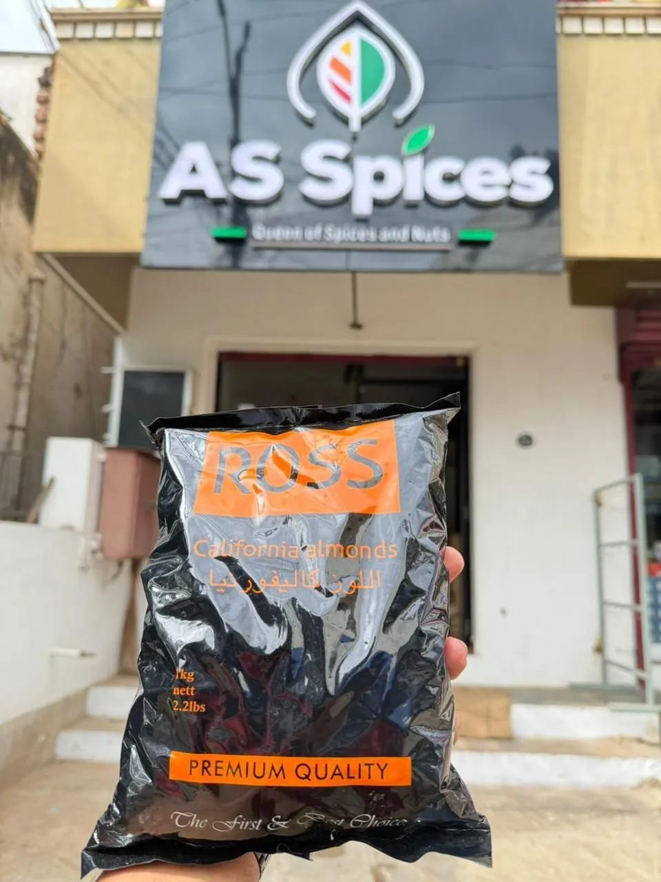 A 1 kg pack of California almonds held up outside the shop