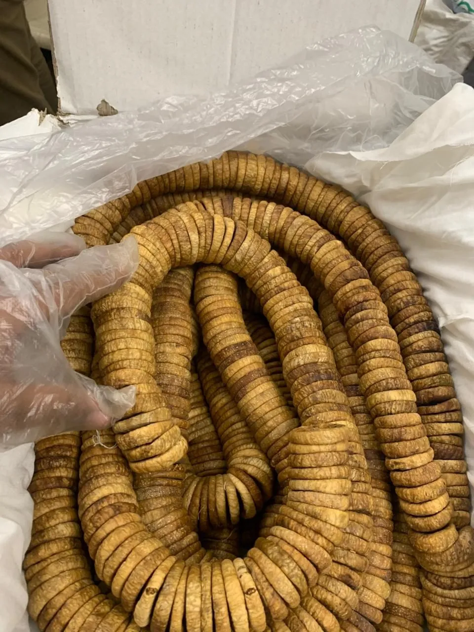 Strings of dried figs in an open carton