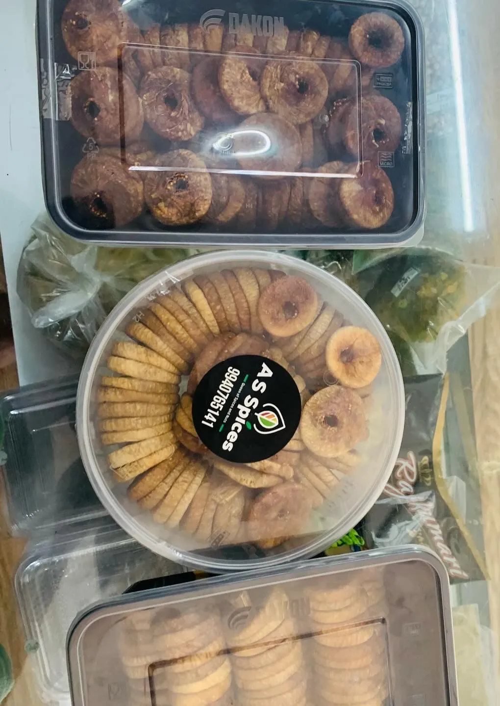 Tubs of dried figs, including one with an A S Spices sticker