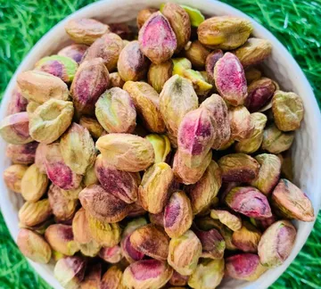 Shelled pistachios in a white bowl