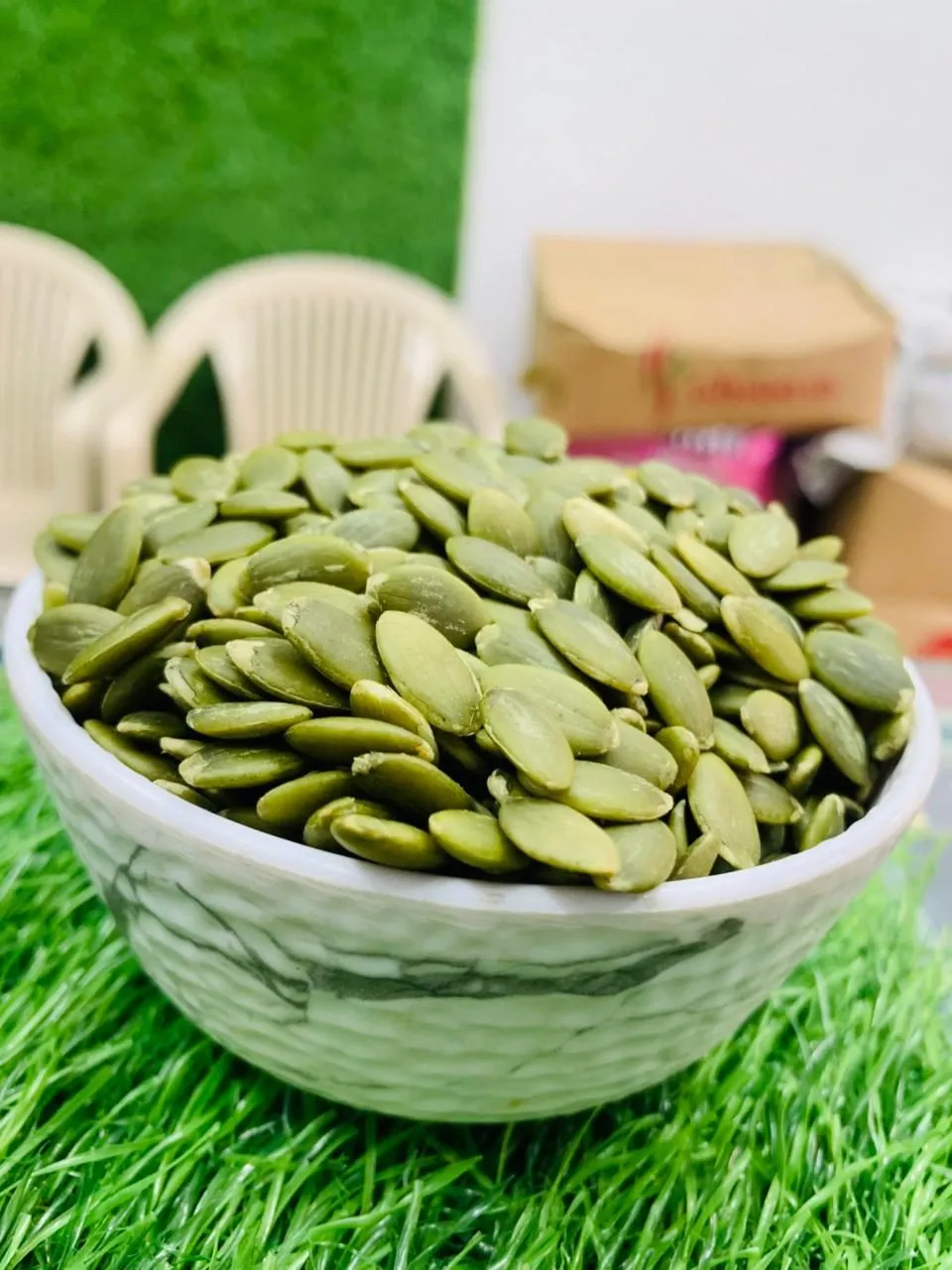 A bowl of green pumpkin seeds
