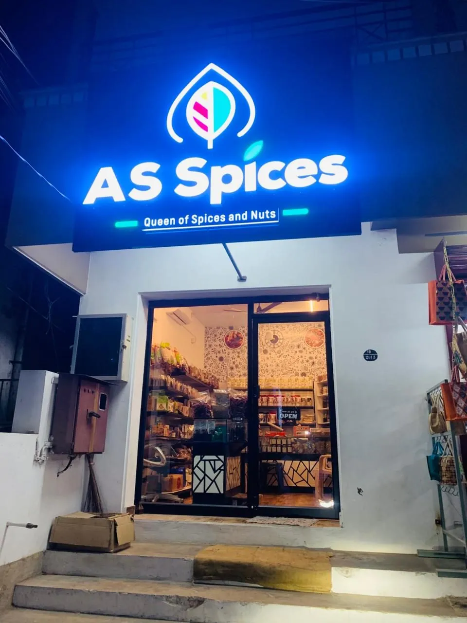 The Ahamed Sons and A S Spices shop front in Cumbum at night, with the lit A S Spices sign